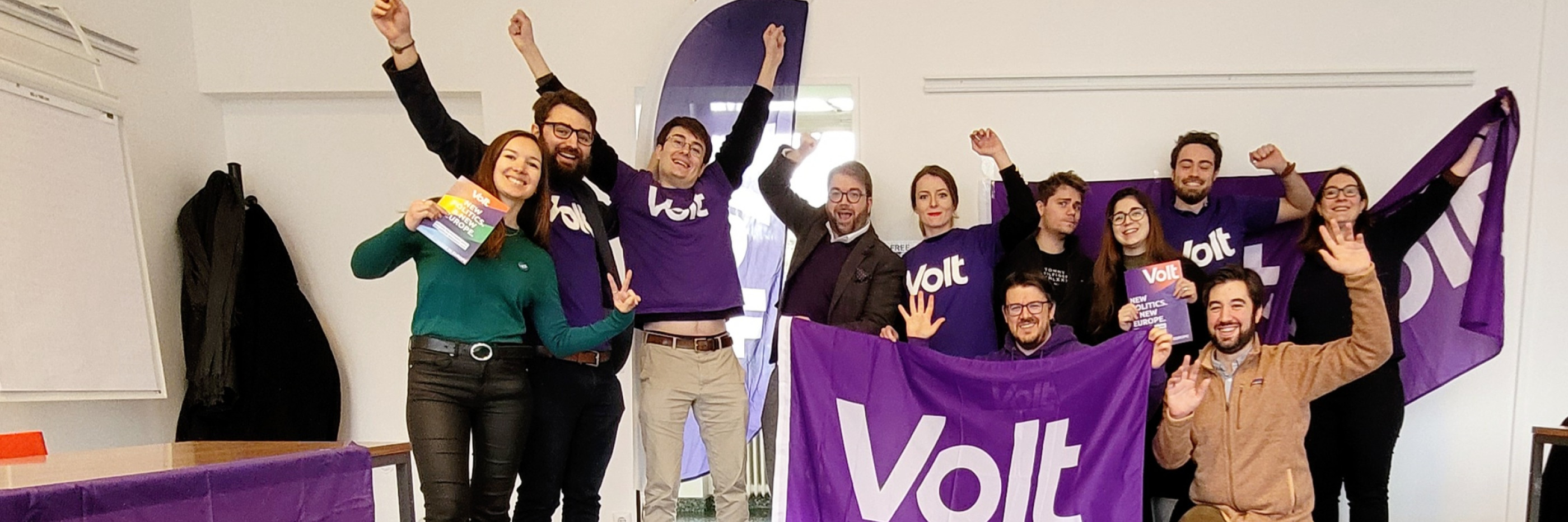 Volters being happy, waving, holding flags