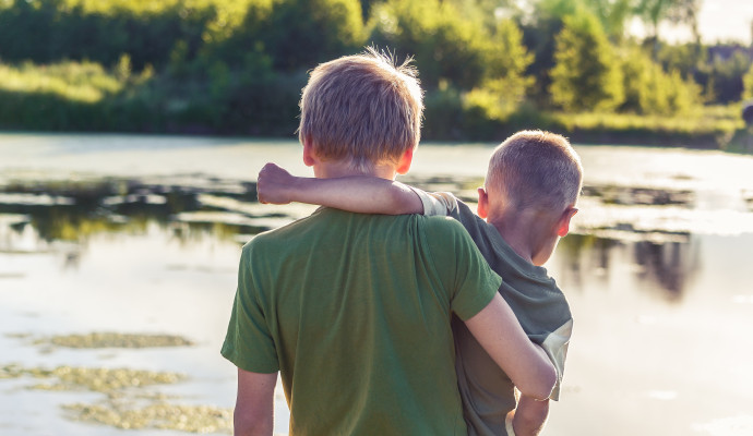 two kids arm in arm