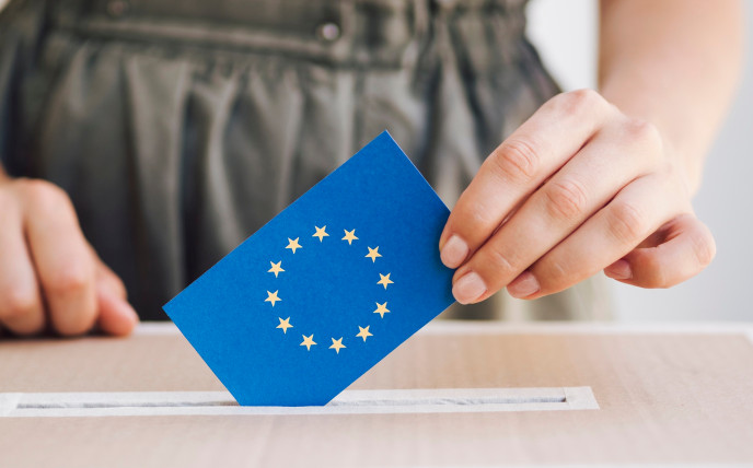 Woman putting her ballot with a european flag on it